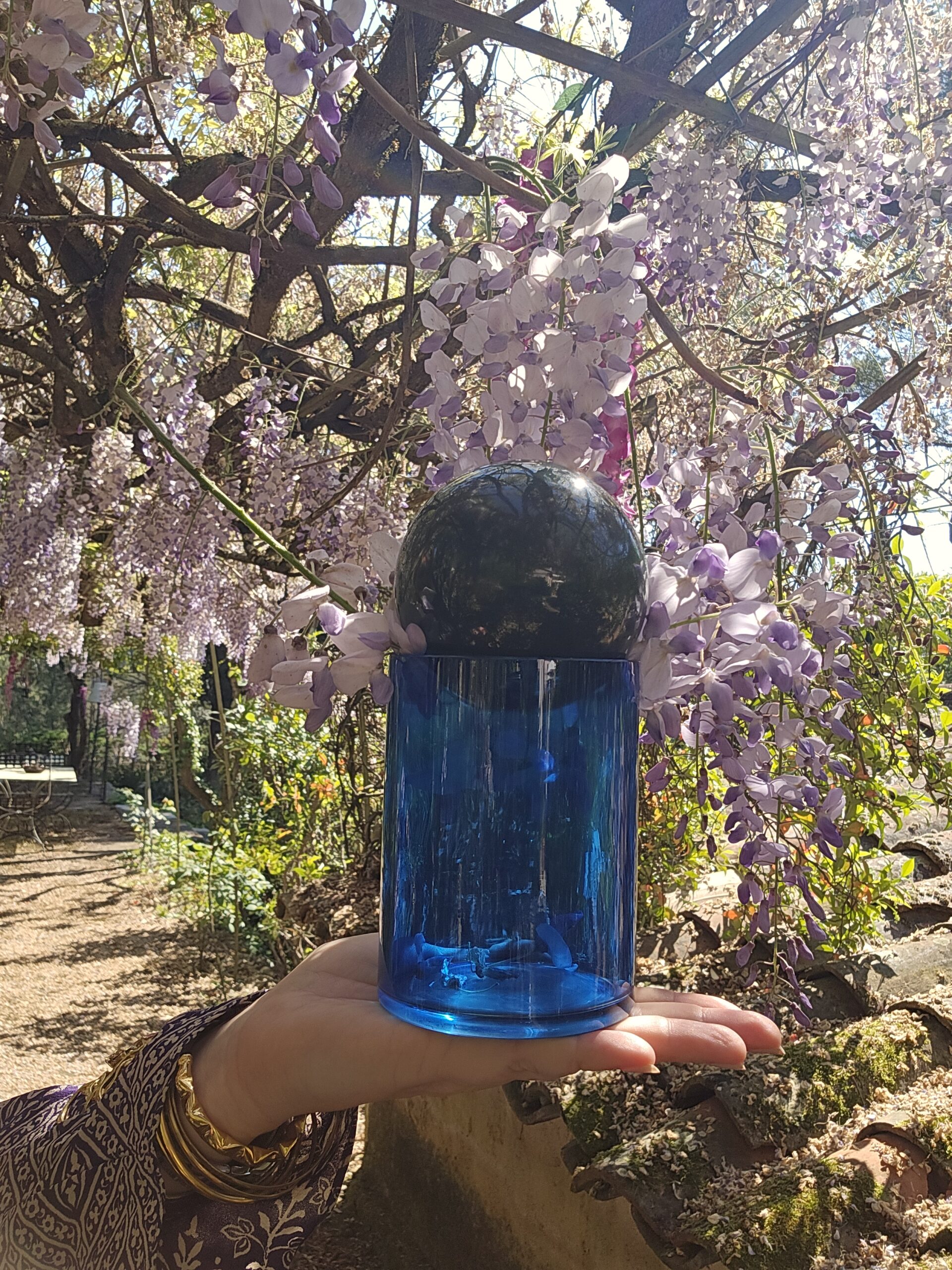 There are moments when time seems to pause – the Wisteria you see here was probably planted at least 70 years ago and is perfect for today's "glass of nature": the scent of wisteria is sweet and strong, Bees dancing in slow motion, A sky so clear, it hums peace.